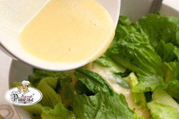 Lettuce leaves under the specialty Caesar sauce