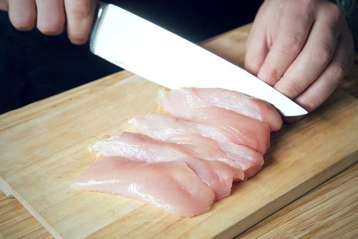 Raw chicken fillet cut in slices