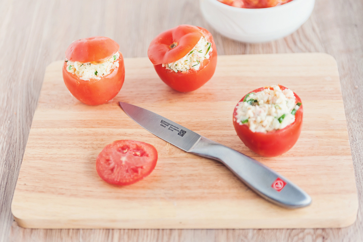 Tomatoes stuffed with chopped shrimps, Parmesan, and garlic with herbs